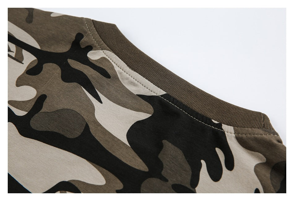 Close-up of a brown ribbed crew neckline on a brown, black, and beige camouflage garment.