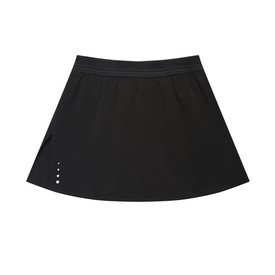 Black high-waist A-line mini skirt with elastic waistband, side slit and white dots at the hem, flat lay