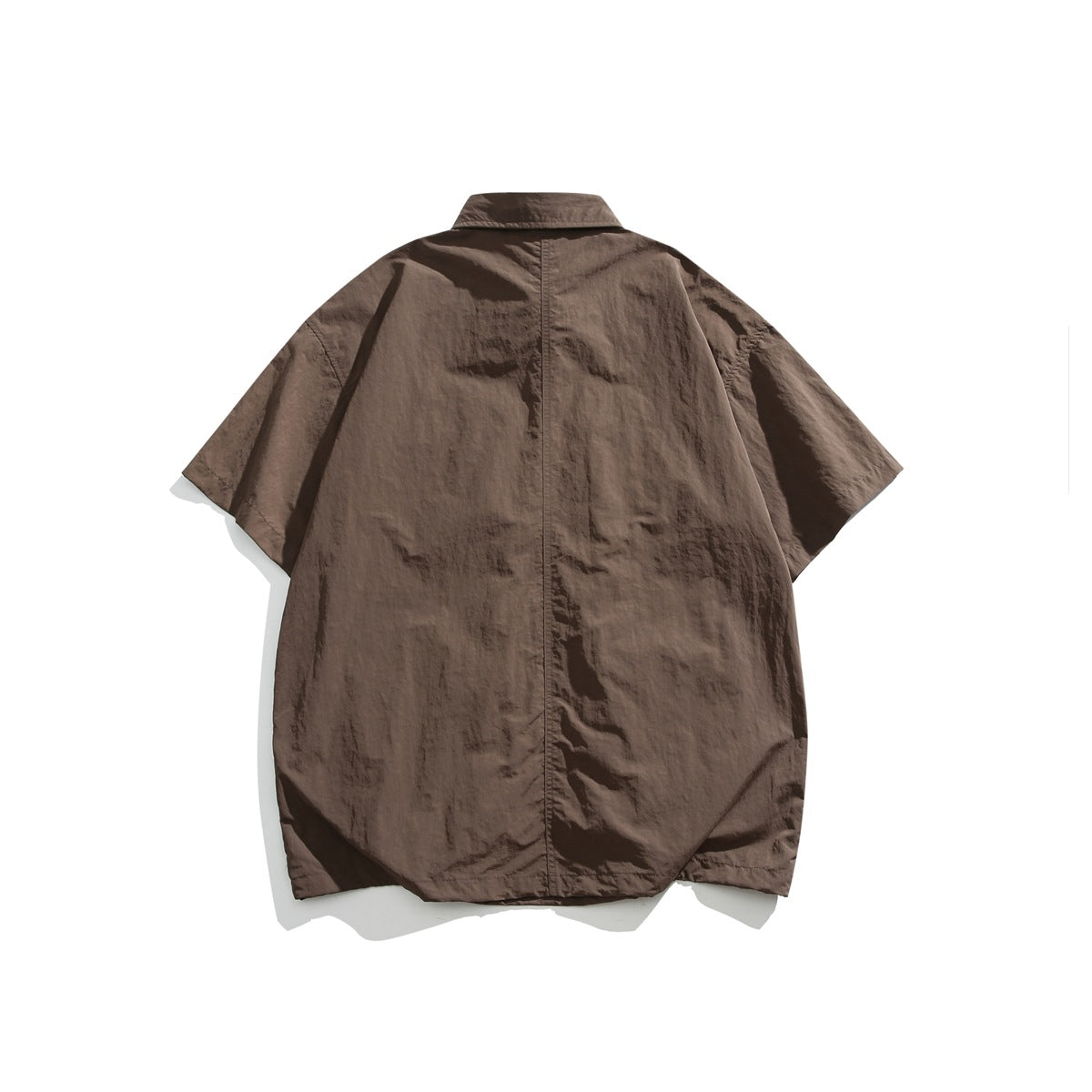 Back view of an oversized brown short-sleeve collared shirt with a center seam.
