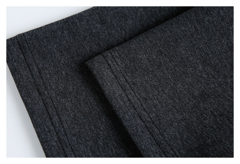 Close-up of charcoal heather fabric with a folded edge and parallel stitching.