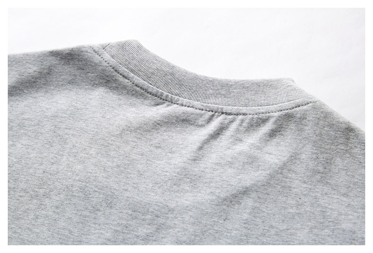 Close-up of the back neckline and shoulder seam on a heather gray T-shirt.