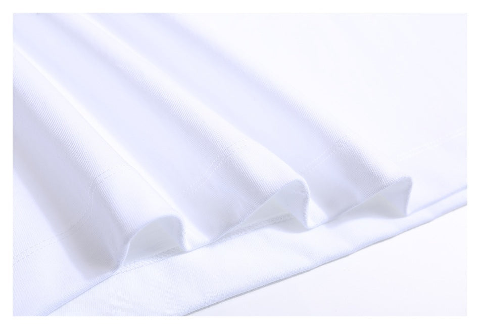 Close-up showing the stitched hem and folds of a white T-shirt.