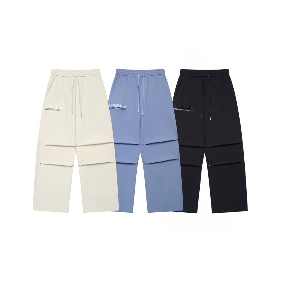 Front views of wide-leg drawstring pants in ivory, light blue, and black, displayed together.