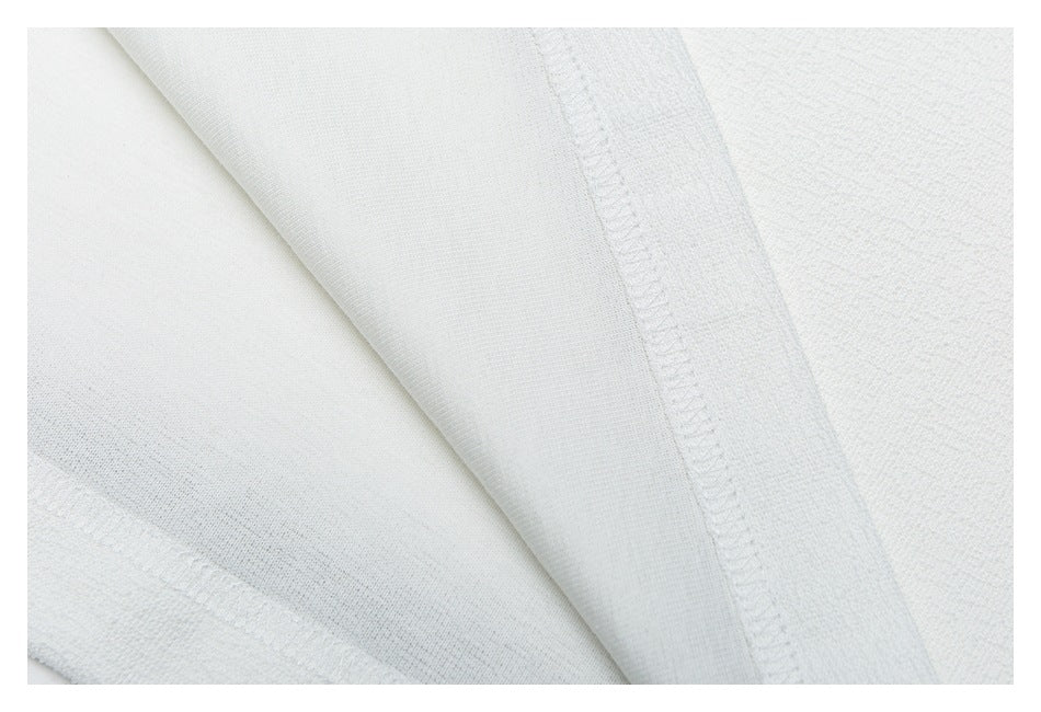 Close-up of the white garment's interior with stitched seams and fabric edges.