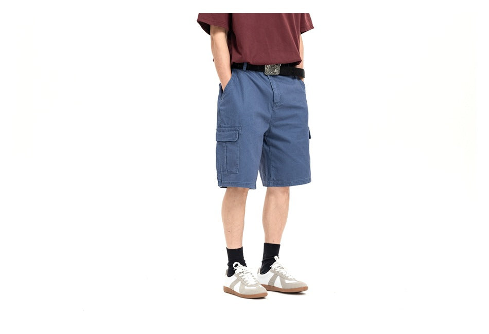 Front view of a model wearing blue cargo shorts with side cargo pockets and a burgundy T-shirt.