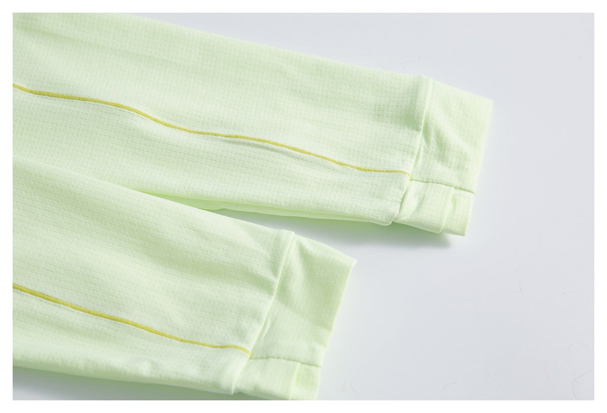 Close-up of two pale lime sleeves with yellow piping and matching cuffs.