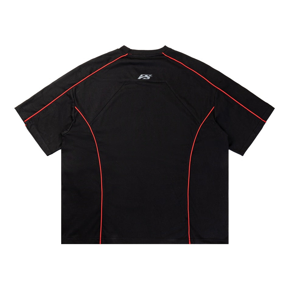 Back view of a black short-sleeve shirt with red piping along the sleeves and back panels.