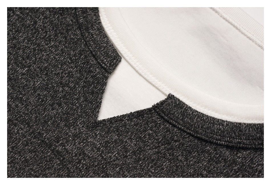 Close-up of the layered neckline, showing the charcoal heather outer collar and white inner shirt.