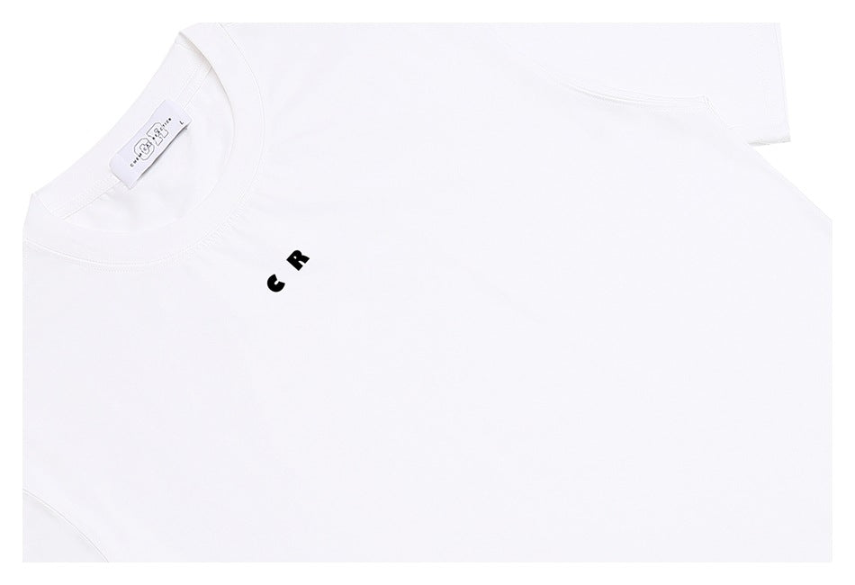 Close-up of a white crew-neck T-shirt with a small black “C R” chest print and visible neck label.