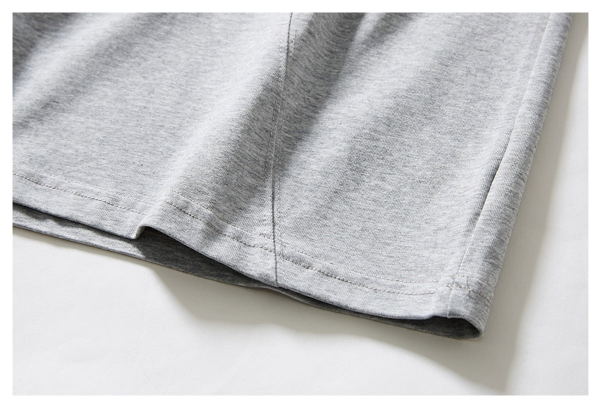 Close-up showing the heather gray T-shirt's bottom hem and side seam.