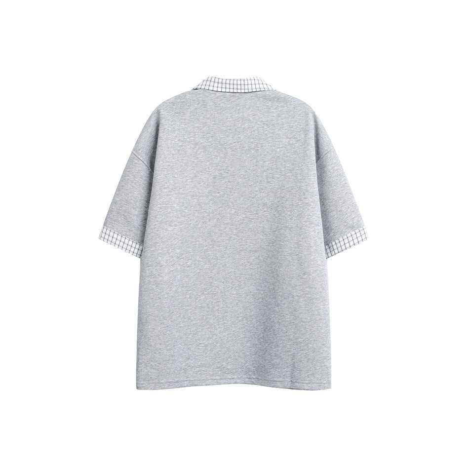 Back view of a loose gray short-sleeve shirt with a black-and-white checked collar and cuffs.