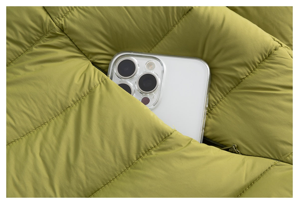 A smartphone tucked into a pocket among the olive-green jacket's quilted panels.