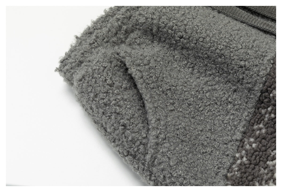 Close-up of a seam or pocket area on gray loop-textured garment fabric.