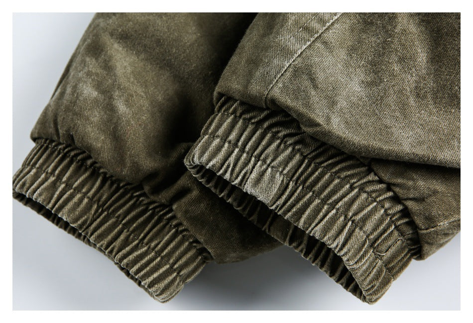 Close-up of gathered elastic cuffs on an olive-gray garment.