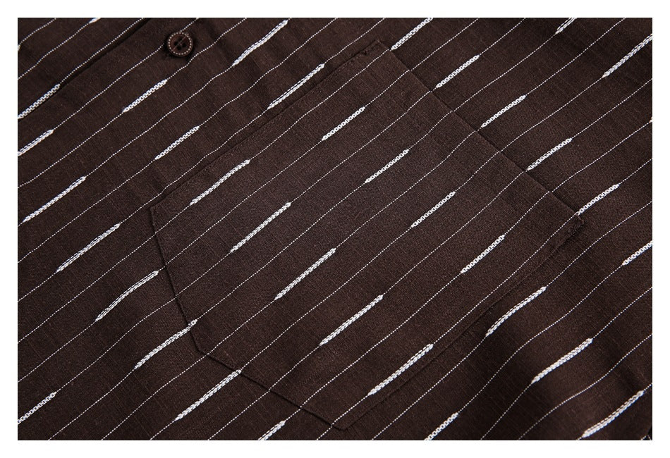 Close-up of a brown garment with thin white dashed stripes, showing a pocket seam and brown button.