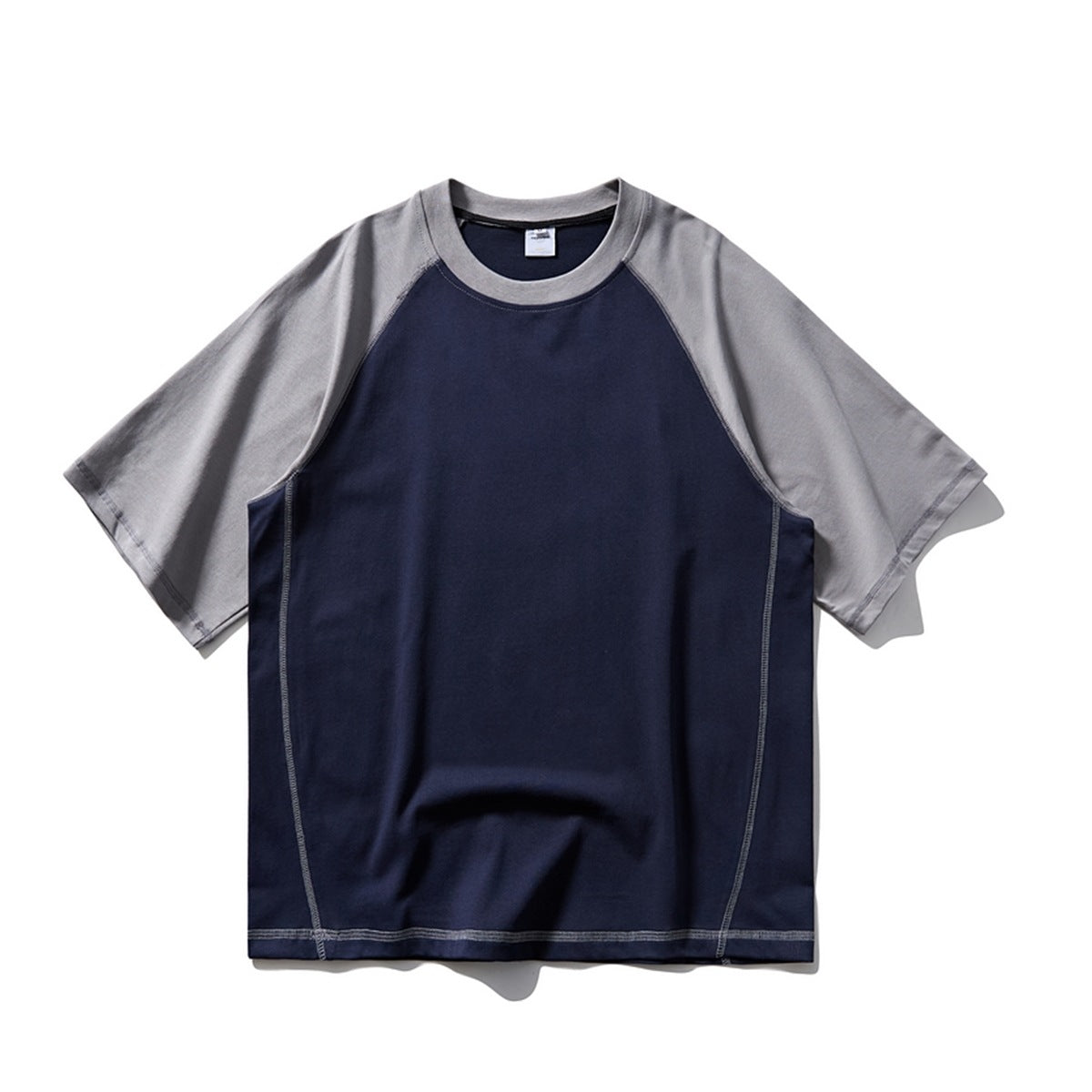 Navy raglan T-shirt with gray sleeves and collar and light contrast topstitching, flat front view