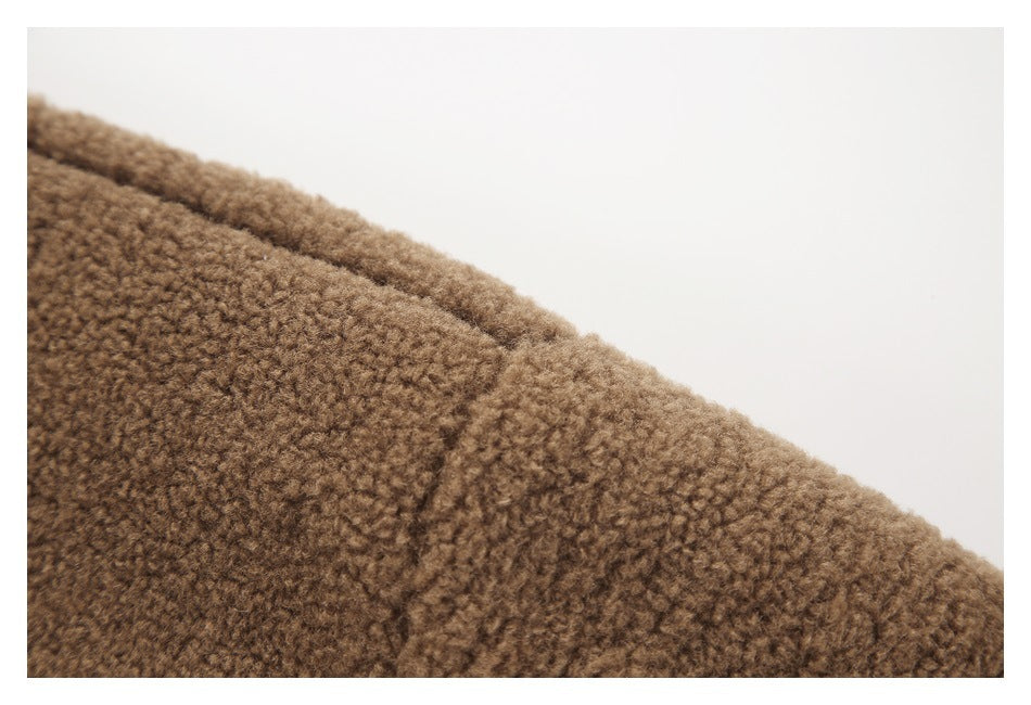 Close-up of brown textured fleece with a curved seam.