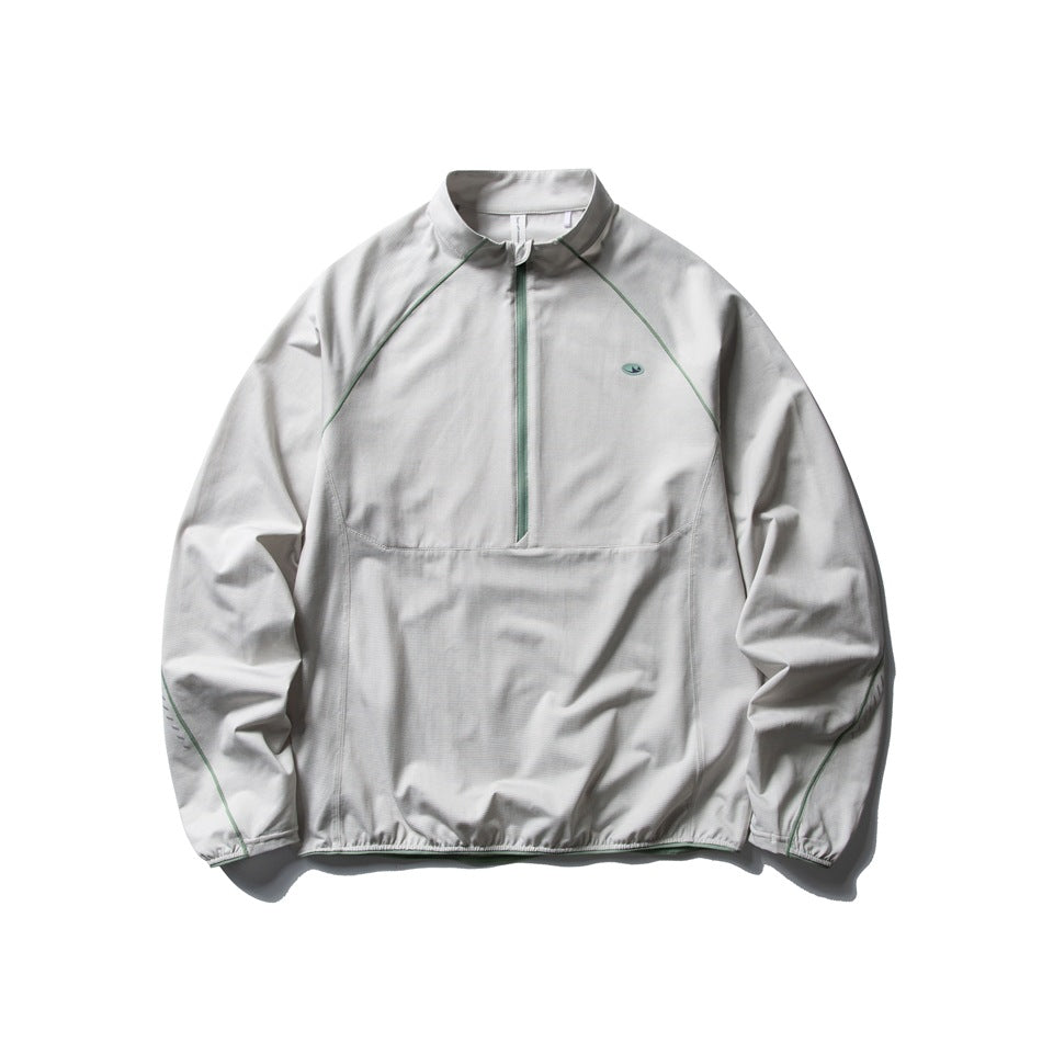 Light gray half-zip stand-collar pullover with green zipper and piping, flat lay front view