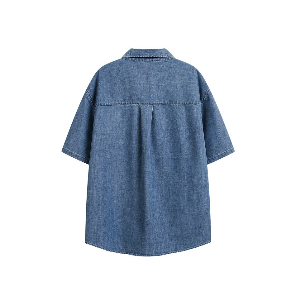 Back view of blue denim-look short-sleeve shirt showing yoke seam and center pleat