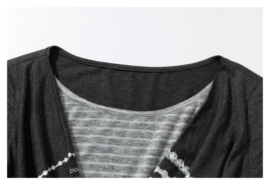 Close-up of the top's wide neckline, showing a light gray striped inset beneath a dark gray outer layer.