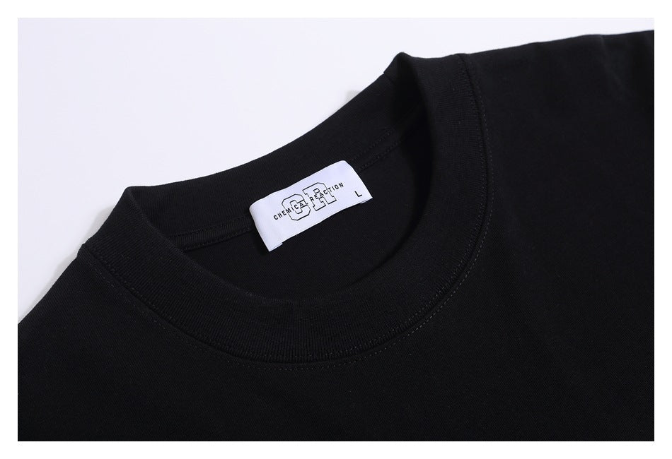 Close-up of a black T-shirt's ribbed crew neck and sewn-in white label.