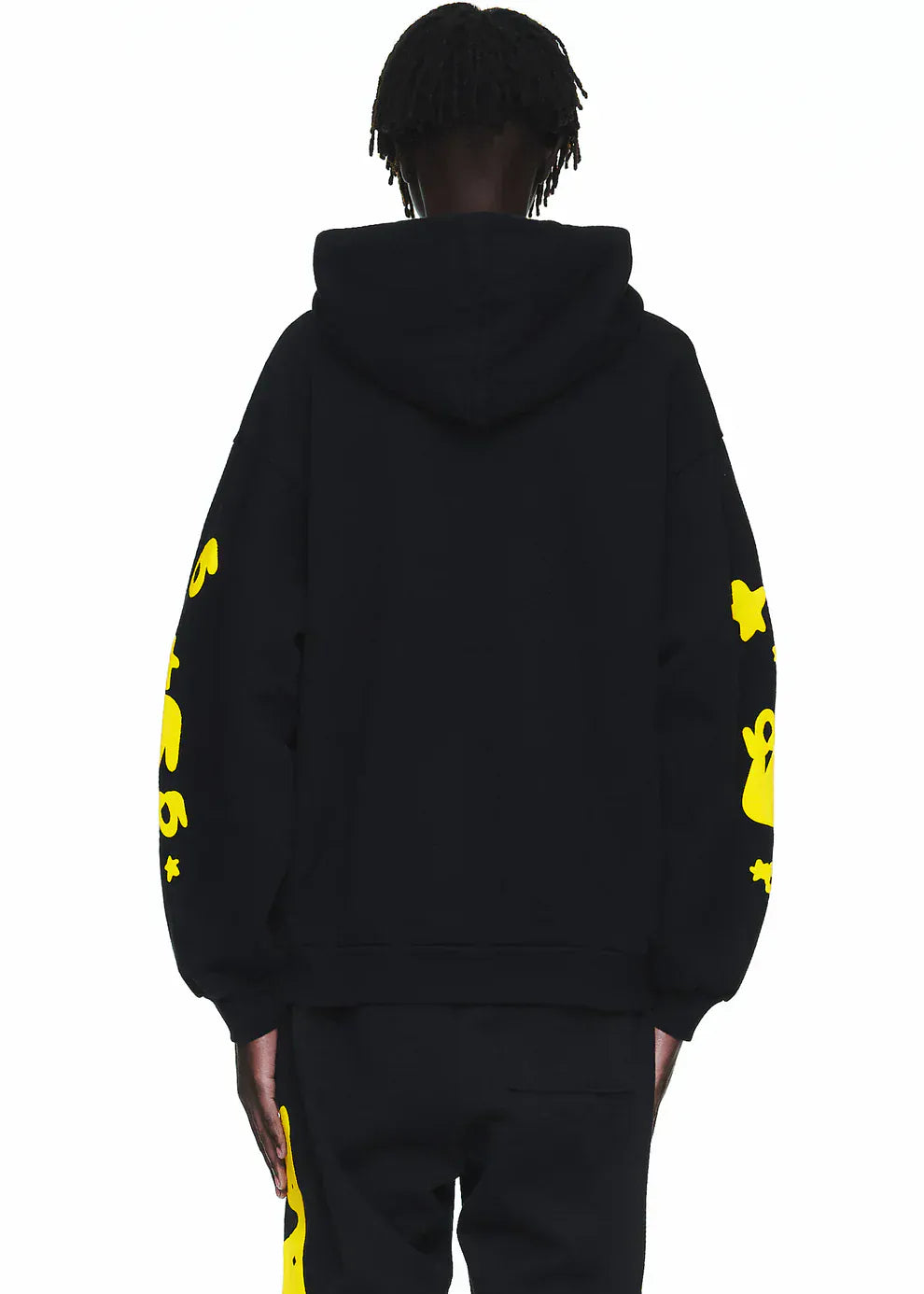 Person wearing a Black and Yellow Spider Hoodie with Star Lettering Print—comfort fit pullover—viewed from the back, paired with black pants featuring yellow accents for a standout streetwear look.