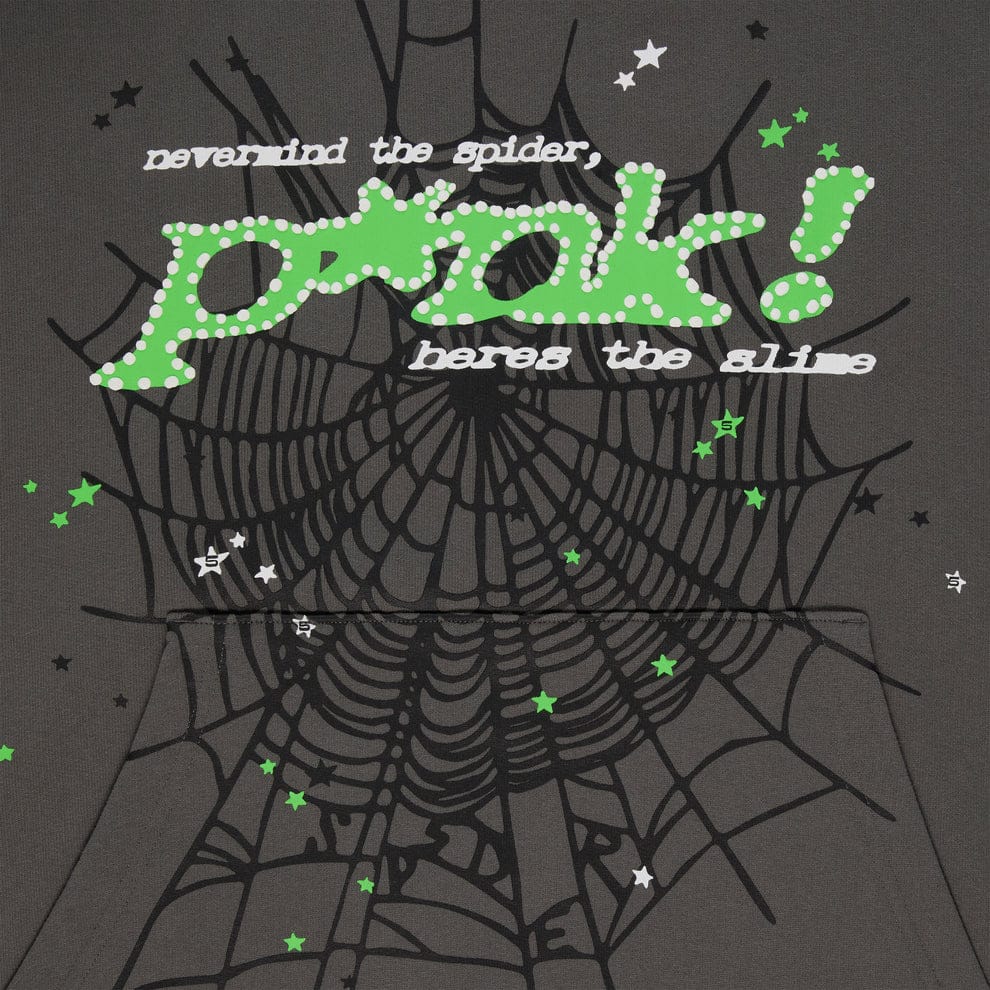 A graphic with a large spiderweb, green and white stars, and text reading never mind the spider, pink! here’s the slime on a dark background—featured on the Sp5der “P!nk! Hares the Slime” Olive Green 440GSM Heavyweight Pullover Hoodie.