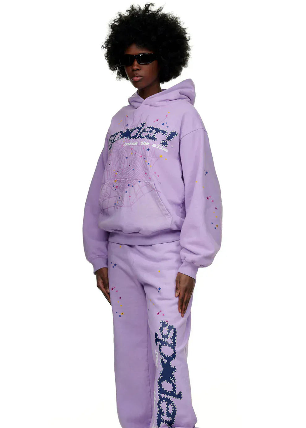 Person wearing the Sp5der “Hares the Slime” Hoodie in lavender purple, a 440GSM heavyweight fleece pullover with spider-web streetwear graphics, showcasing a trendy look against a white background.