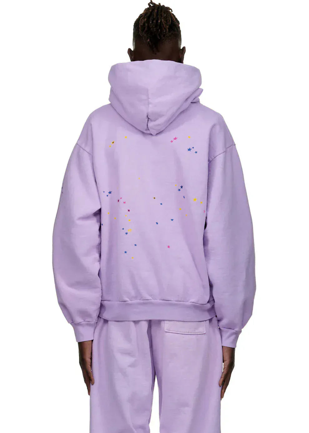 Person seen from the back wearing the Sp5der “Hares the Slime” Hoodie in lavender purple, a 440GSM heavyweight streetwear pullover with colorful specks on the upper back and matching pants.