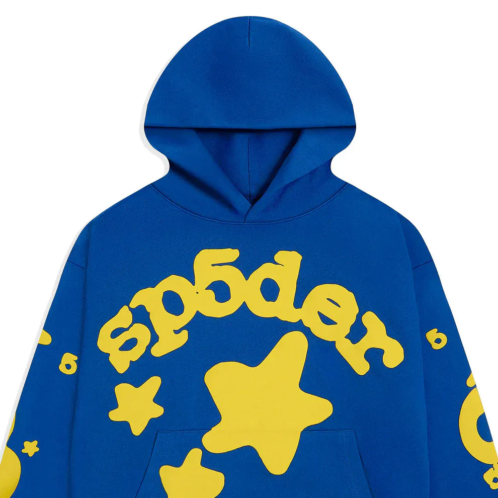 The Sp5der 440GSM Heavyweight Hoodie in royal blue features bold yellow 3D puff star graphics and "sp5der" text, making it a standout choice for Y2K streetwear style.