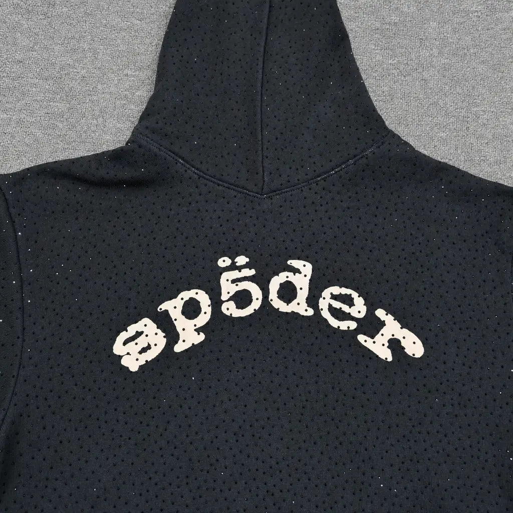 The Sp5der Black Rhinestone Hoodie features a cream arch logo across the back, subtle rhinestone embellishments, small dotted patterns, and is made from cotton―a standout piece in any streetwear collection.