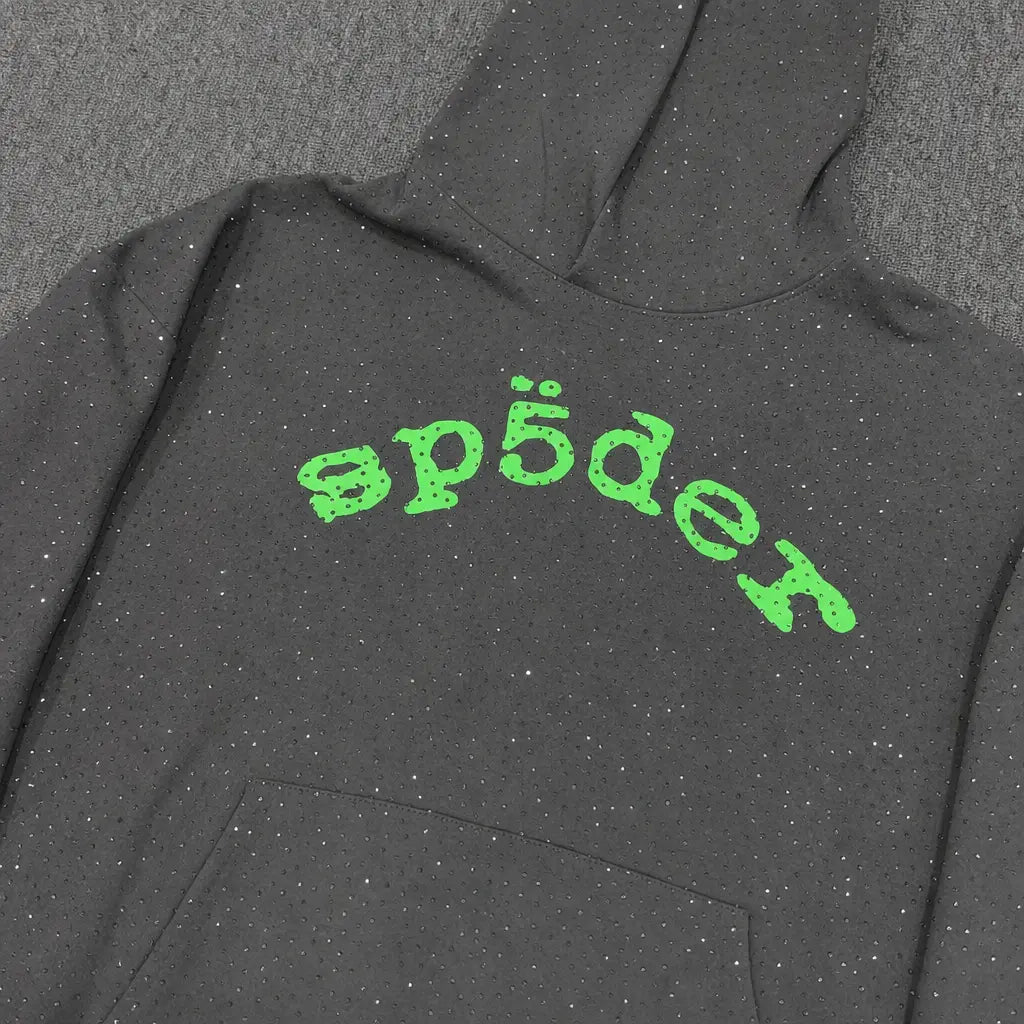 The Sp5der Dark Grey Rhinestone Hoodie Green Arch Logo features bold green arch text and a streetwear vibe―ideal for those seeking the iconic rhinestone hoodie style.