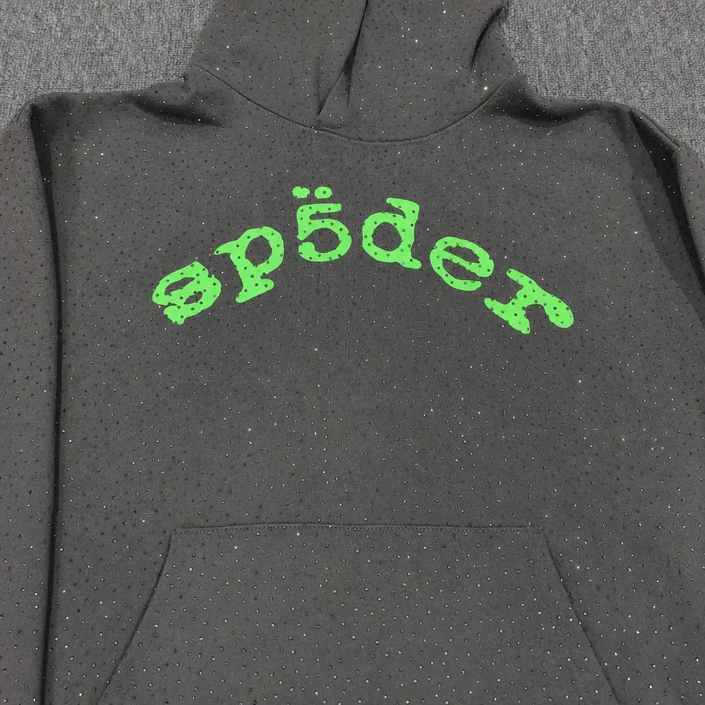 The Sp5der Dark Grey Rhinestone Hoodie Green Arch Logo features dark grey fabric, small sparkling rhinestones, and a bold green arch "sp5der" logo on the chest―an ideal streetwear piece.