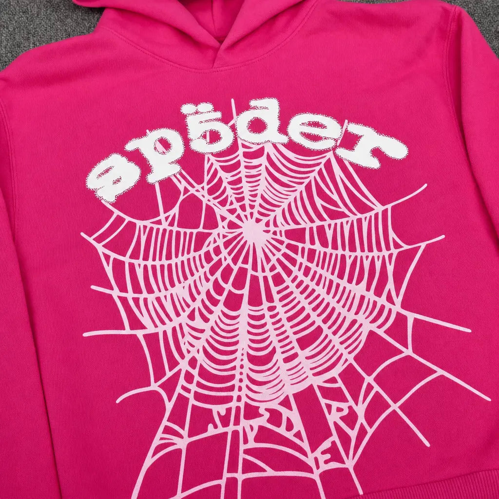 The Sp5der OG Web Hoodie Hot Pink features a bold white spiderweb front print and playful "spider" lettering―a standout, eye-catching piece for any streetwear collection.