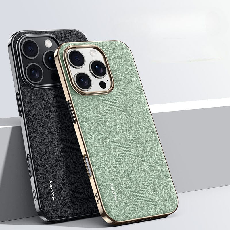 Two iPhone 16 Pro Max Premium Leather Cases, one black and one green, are positioned upright against a neutral background. These shockproof design cases feature the word "HAPPY" in small print at the bottom and have a refined metal button finish.