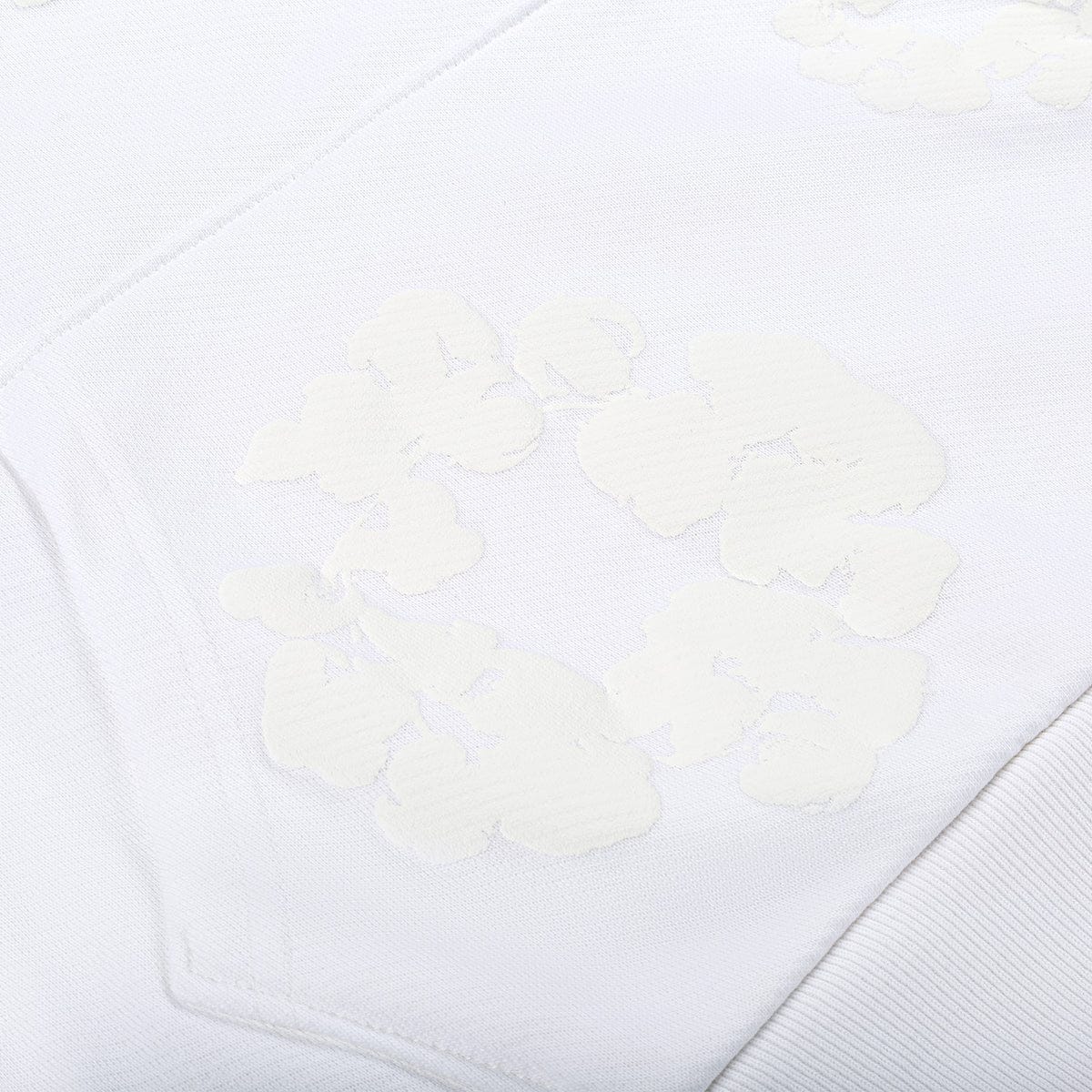 Close-up of the White Monochrome “Cotton Wreath” Denim Tears Hoodie, showcasing its raised, textured floral-like patterns in soft white—a nod to the detailed minimal streetwear design.