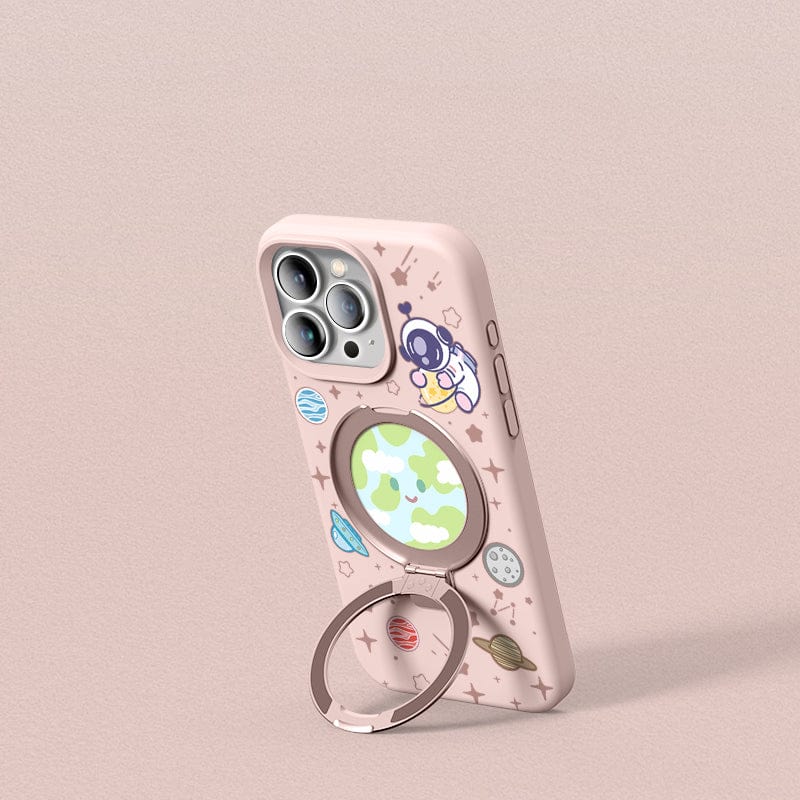An iPhone 16 Pro Max in a Pink Silicone MagSafe Case with Stand, featuring a space theme complete with planets and stars, rests in an open beige box with an additional slot for another phone or accessory.