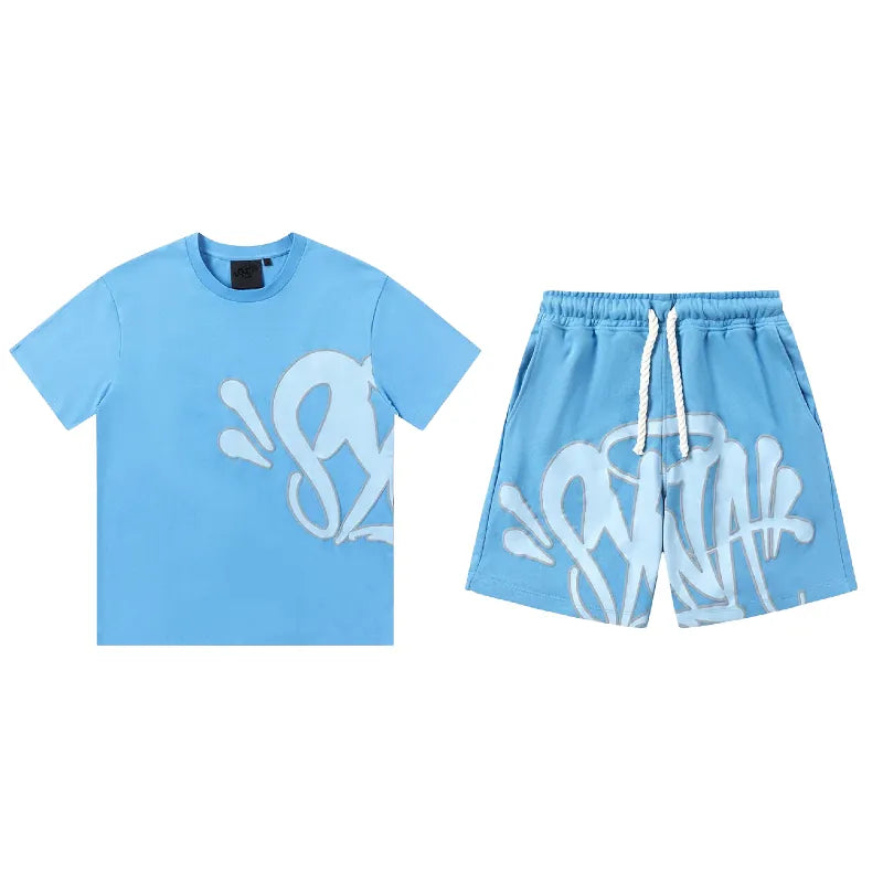 The Syna World T-Shirt and Shorts Set with Accessories, available in 8 colors, features white graffiti-style lettering and a white drawstring for a standout streetwear look.