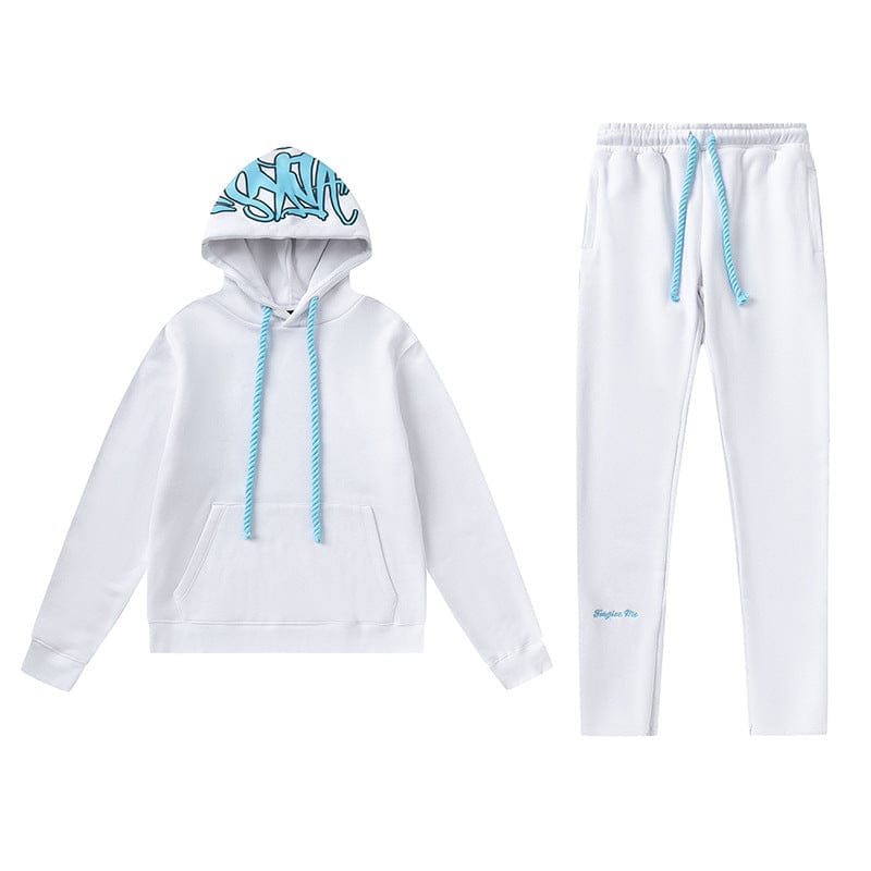The Syna World Tracksuit Set includes a white graphic hoodie with blue drawstrings and flared pants with subtle blue ankle text, featuring graffiti art inside the hood—part of the signature collection.