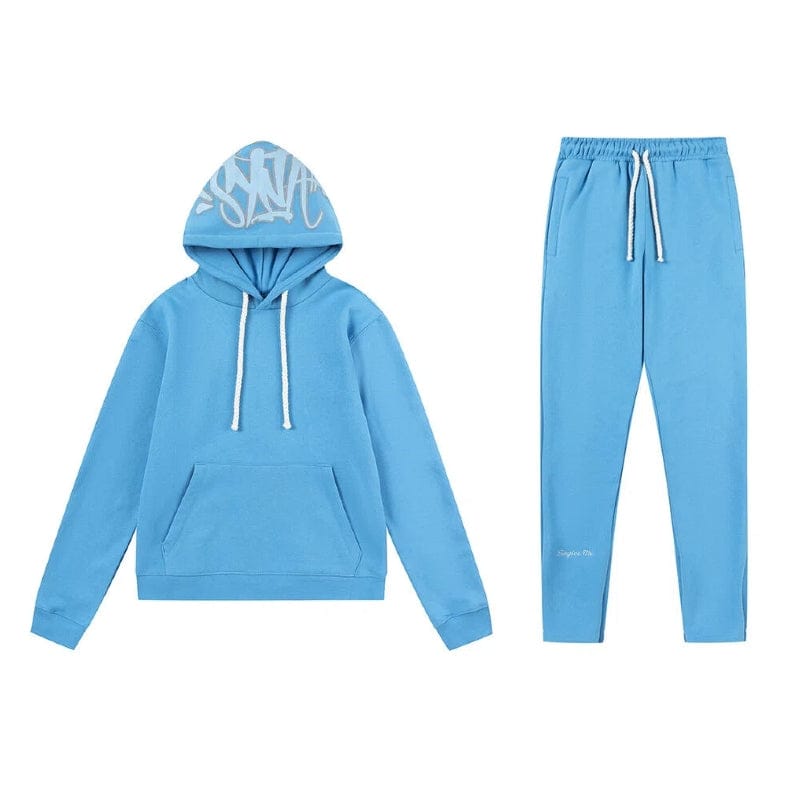 The Syna World Tracksuit Set includes a light blue graphic hoodie with white drawstrings and matching flared pants featuring an elastic waistband and coordinating white drawstrings.