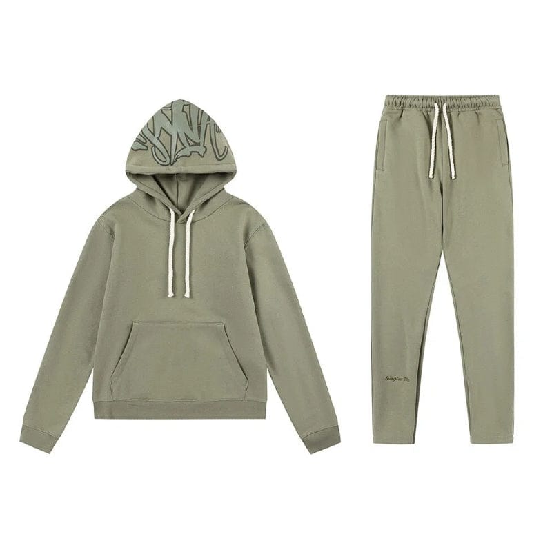 The Syna World Tracksuit Set pairs a graphic hoodie with flared pants and accessories, both in olive green with subtle accents—part of the signature Syna collection.