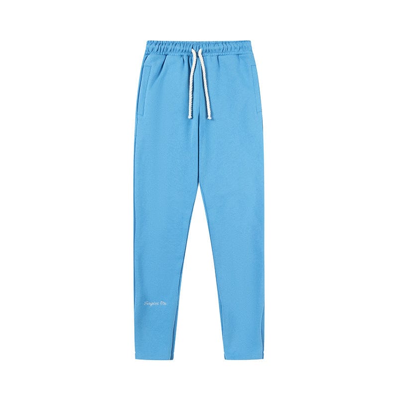 Light blue Syna World Matching Tracksuit Pants – Streetwear Jogger Pants in 6 Colors, featuring an elastic waistband, white drawstring, side pockets, and tapered legs, displayed on a white background.