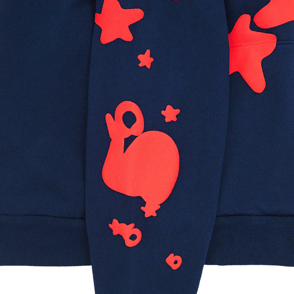 The Sp5der 440GSM Heavyweight Hoodie is a navy blue streetwear pullover featuring bold red star puff prints on the sleeve, perfect for fans of standout Y2K-inspired fashion.