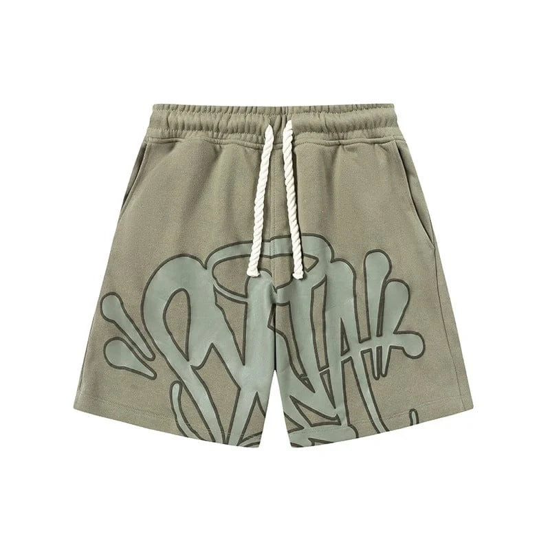 The Syna World Graffiti Graphic Print Olive Green Shorts feature heavyweight fleece, a white drawstring, side pockets, an elastic waistband, and an abstract graffiti print on the front. Displayed on a white background.