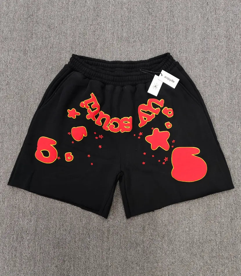 Sp5der black jogger shorts with red and yellow letter graphic and star print on the front