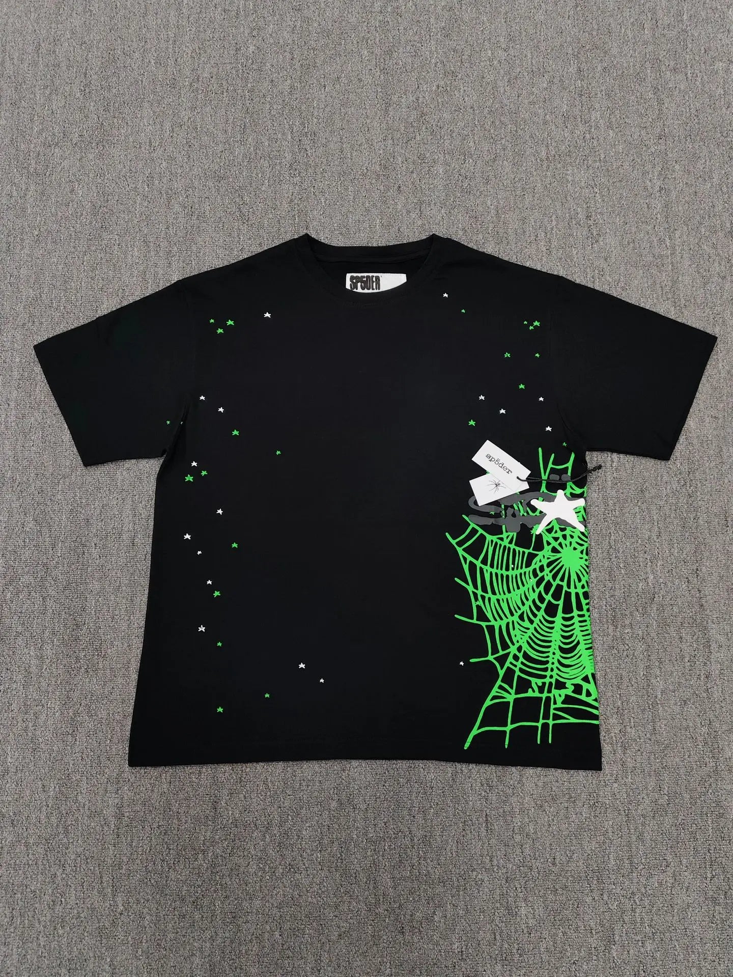 Sp5der black short sleeve t-shirt with green spider web graphic and scattered star prints on the front