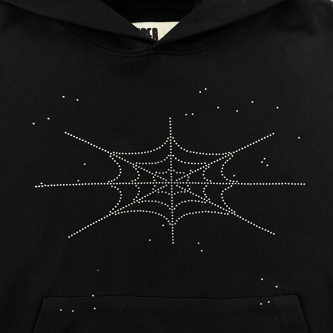 The Sp5der Black Rhinestone Spiderweb Crystal Hoodie is a streetwear hoodie with a chest spider web made of white rhinestone-like dots, plus scattered dots for a standout, crystal-inspired look.