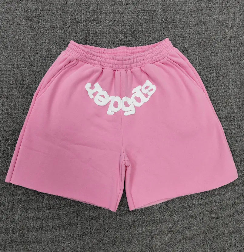 Pink Sp5der jogger shorts with white bubble letter front print and elastic waistband, laid flat